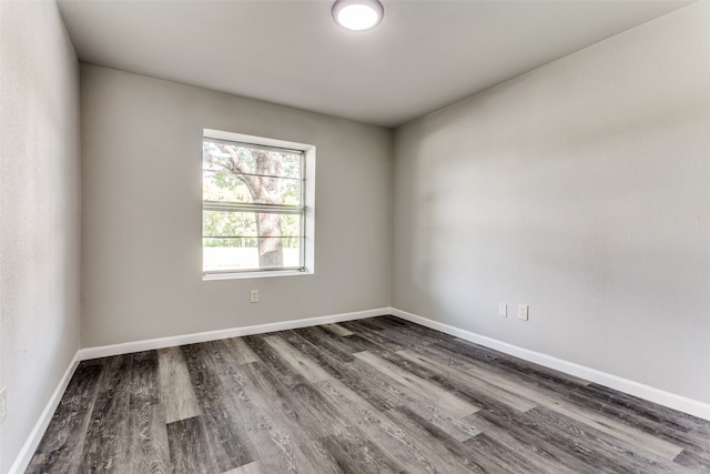 empty room with dark wood-type flooring