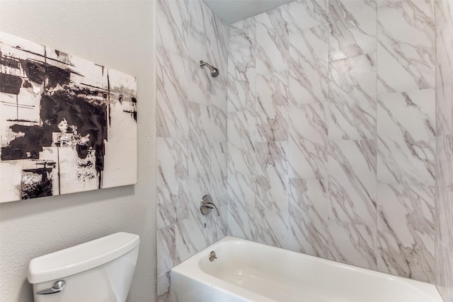 full bathroom featuring toilet, a textured wall, and bathtub / shower combination