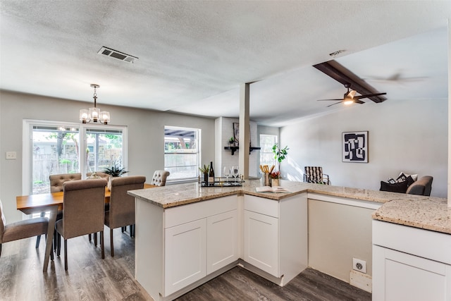 kitchen featuring a textured ceiling, ceiling fan with notable chandelier, white cabinetry, and dark hardwood / wood-style flooring