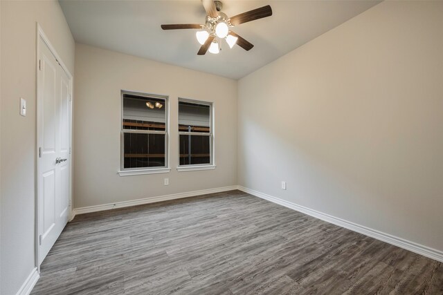 unfurnished room with ceiling fan and wood-type flooring