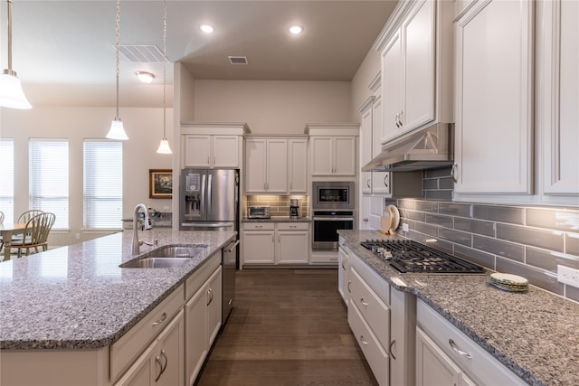 kitchen featuring pendant lighting, sink, an island with sink, white cabinets, and stainless steel appliances