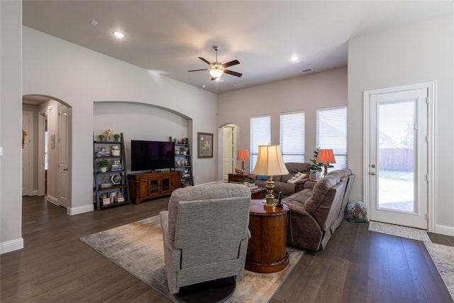 living room featuring ceiling fan and dark hardwood / wood-style floors