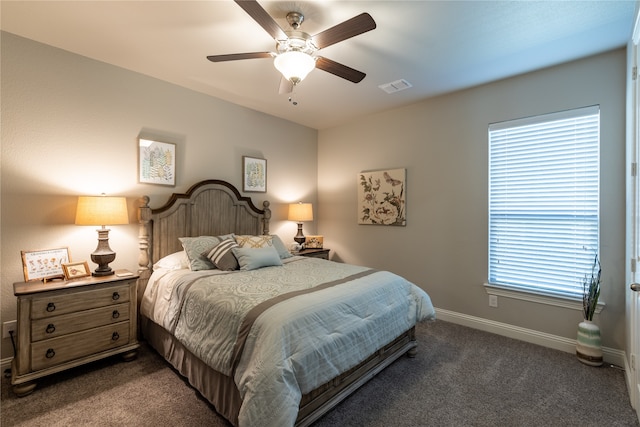 bedroom with dark colored carpet and ceiling fan