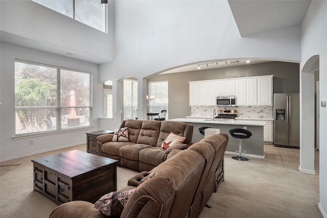 carpeted living room with a high ceiling