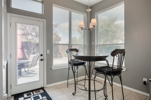 tiled dining area featuring a notable chandelier