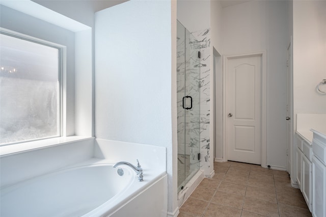 bathroom featuring tile patterned floors, independent shower and bath, and vanity