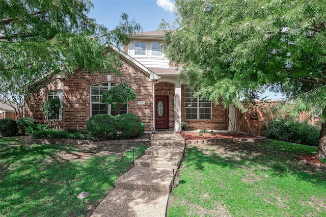 view of property hidden behind natural elements with a front lawn