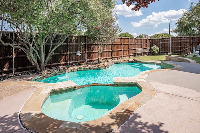 view of swimming pool featuring an in ground hot tub