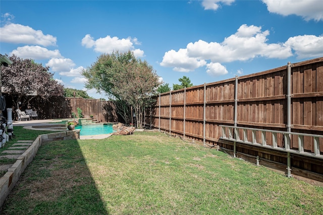 view of yard with a fenced in pool and a patio area