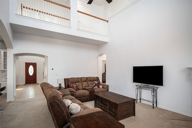 carpeted living room featuring a high ceiling