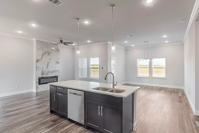 kitchen featuring ceiling fan, sink, a high end fireplace, stainless steel dishwasher, and a kitchen island with sink