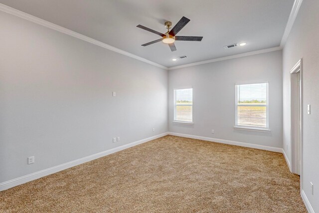 carpeted empty room with ornamental molding and ceiling fan