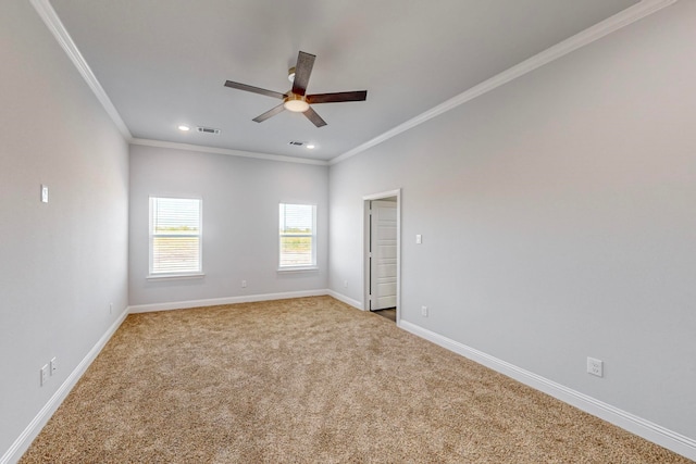 carpeted spare room with ornamental molding and ceiling fan