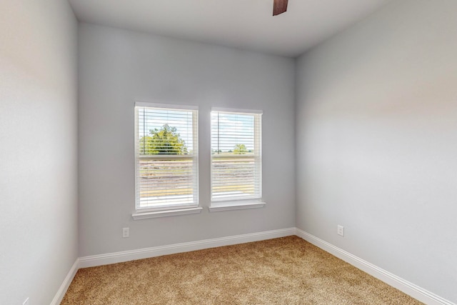 unfurnished room featuring ceiling fan and light carpet