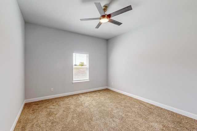 spare room with ceiling fan and light colored carpet