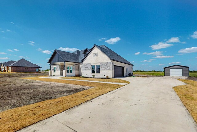 view of front of home featuring a garage, covered porch, and a front yard