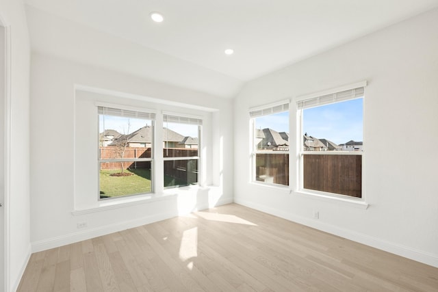 interior space with light hardwood / wood-style floors and lofted ceiling