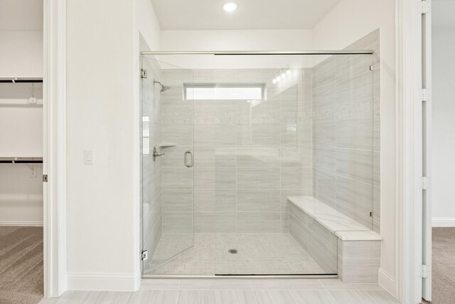 bathroom featuring a shower with shower door