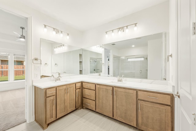 bathroom with vanity, tile patterned floors, ceiling fan, and a shower with shower door