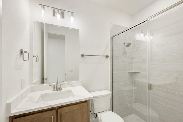 bathroom featuring vanity, toilet, and walk in shower