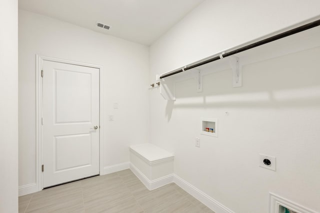 clothes washing area featuring hookup for an electric dryer, gas dryer hookup, and hookup for a washing machine