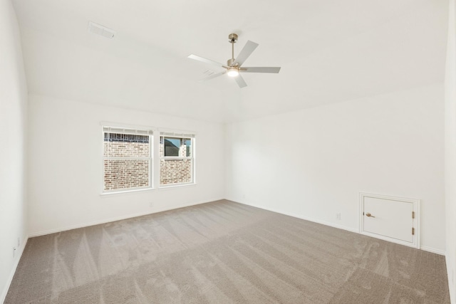 carpeted spare room with ceiling fan