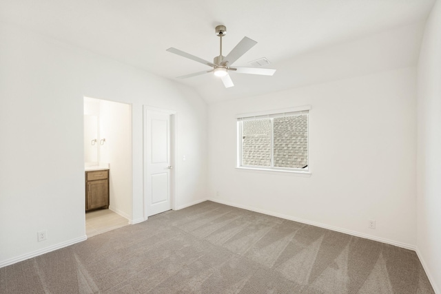 spare room featuring ceiling fan, lofted ceiling, and light carpet