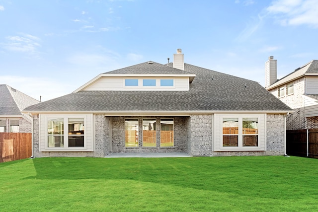 rear view of property with a yard and a patio