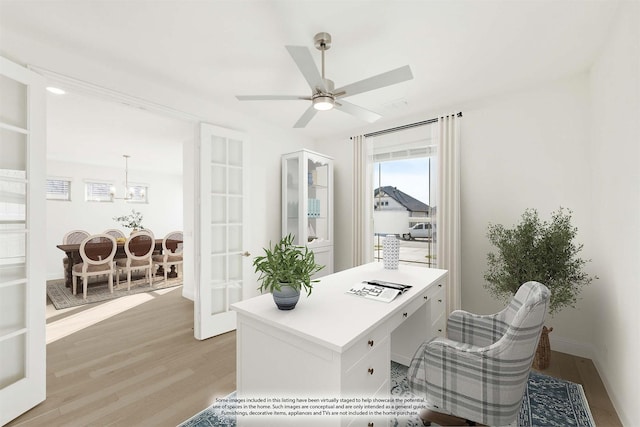 office with ceiling fan, french doors, and light hardwood / wood-style floors