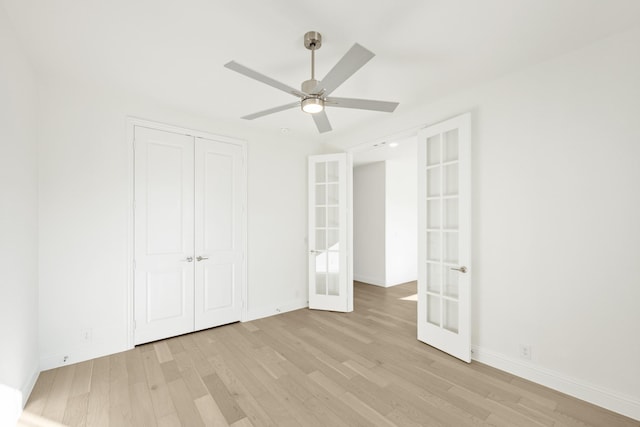 unfurnished bedroom featuring french doors, a closet, light hardwood / wood-style floors, and ceiling fan