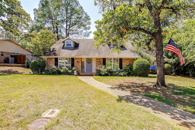 view of front of home featuring a front yard and cooling unit