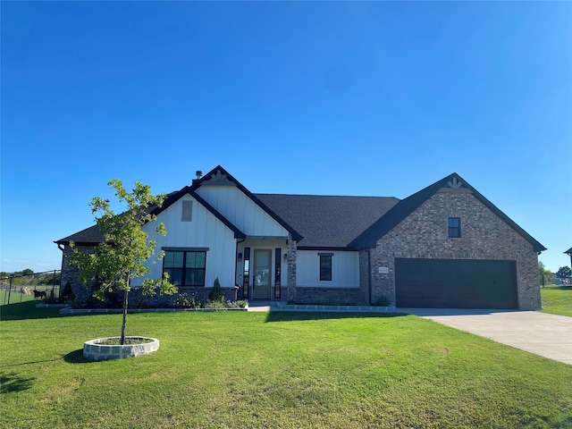 view of front of property featuring a garage and a front yard