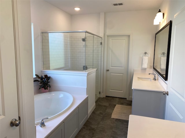 bathroom featuring vanity, plus walk in shower, and tile patterned flooring