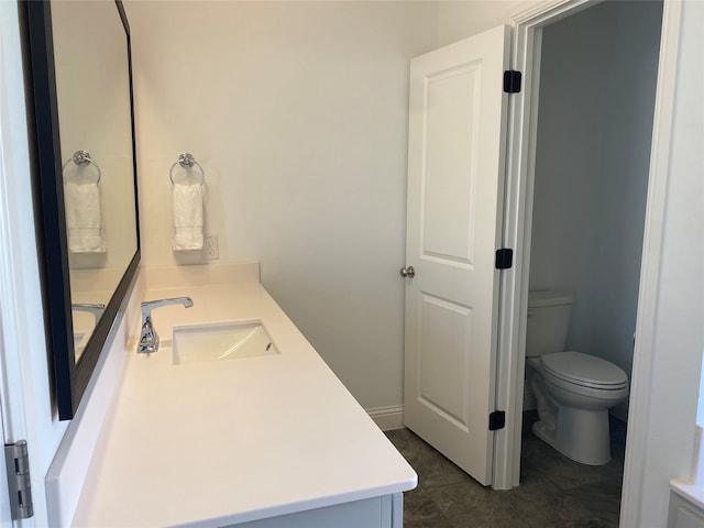 bathroom with tile patterned flooring, vanity, and toilet