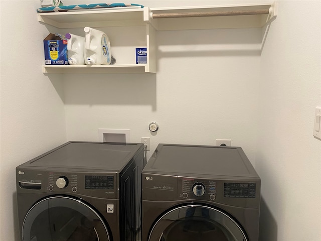 clothes washing area featuring independent washer and dryer