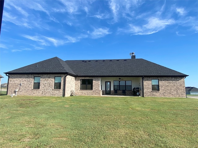 rear view of property with a lawn