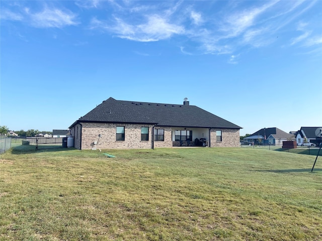 rear view of house with a lawn