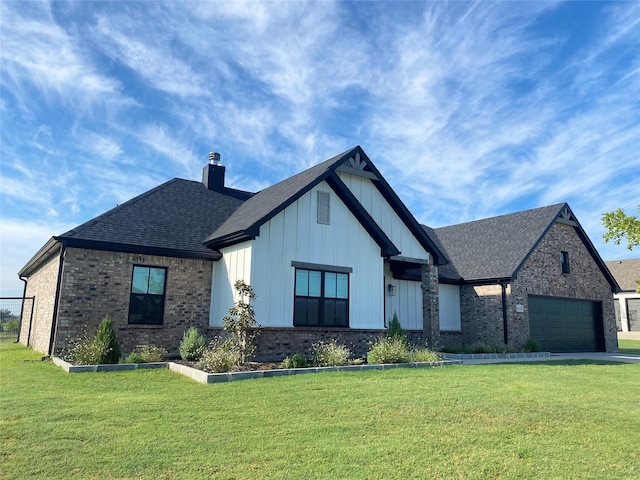 view of front of property with a front yard and a garage