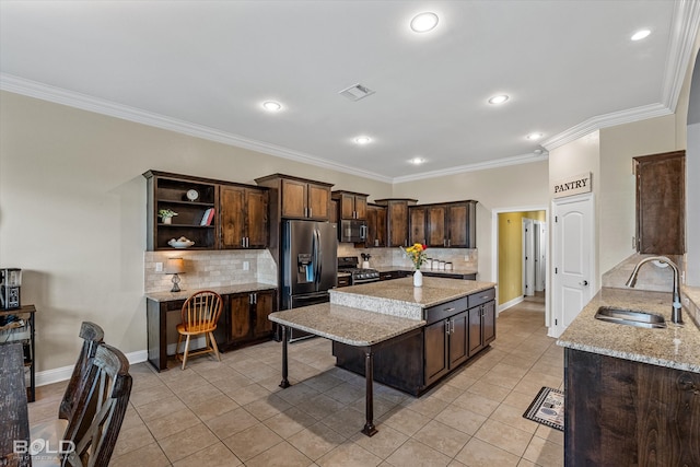 kitchen featuring light stone countertops, light tile patterned floors, stainless steel appliances, dark brown cabinetry, and sink