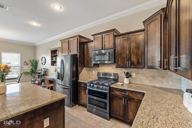 kitchen with dark brown cabinets, stainless steel appliances, light stone counters, and crown molding