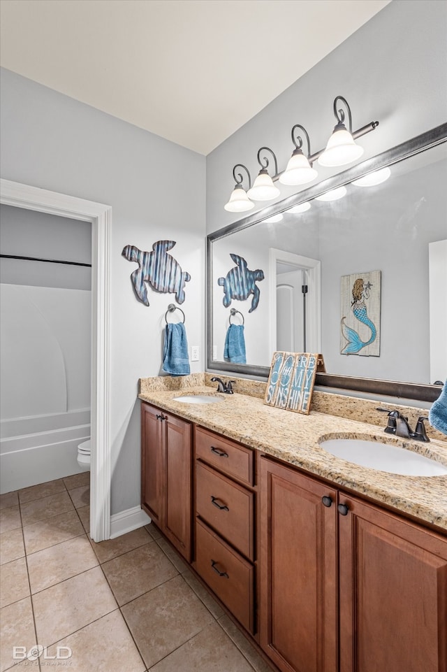 bathroom with tile patterned floors, a bathtub, vanity, and toilet