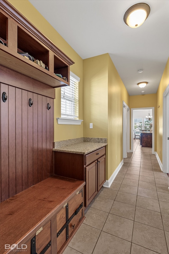 mudroom with light tile patterned floors and plenty of natural light