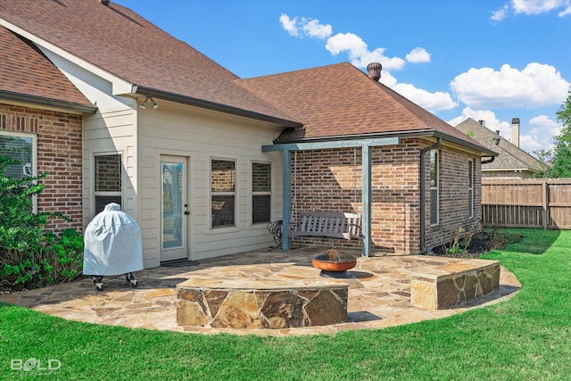 rear view of property featuring a lawn and a patio