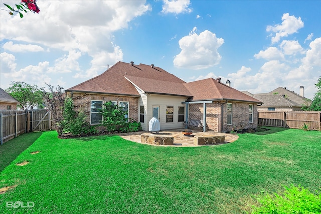 back of house with a patio area and a yard