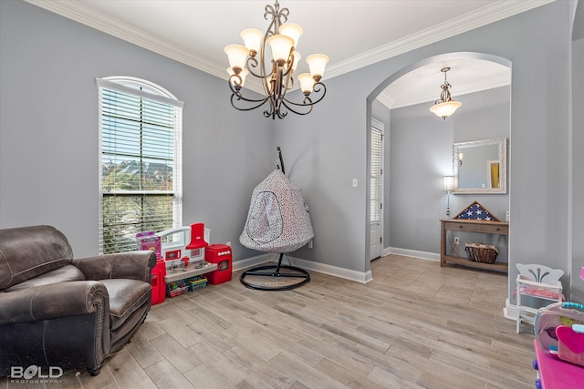 living area with light hardwood / wood-style flooring, a notable chandelier, and ornamental molding