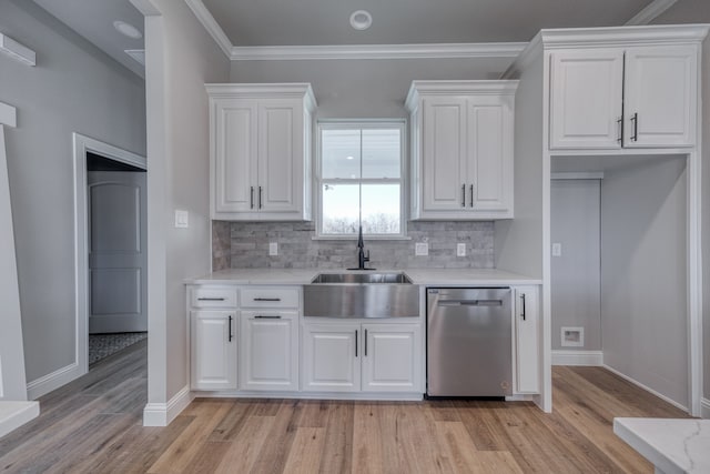 kitchen with light hardwood / wood-style flooring, white cabinetry, sink, and stainless steel dishwasher