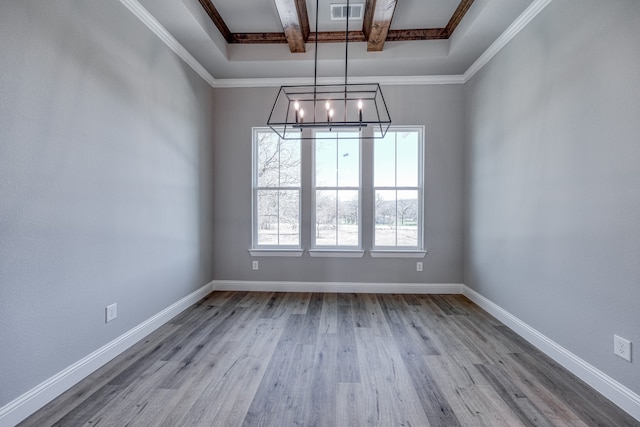 unfurnished room featuring ornamental molding, light wood-type flooring, and beam ceiling