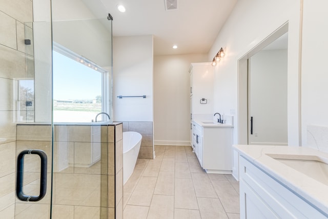 bathroom featuring tile patterned floors, independent shower and bath, and vanity