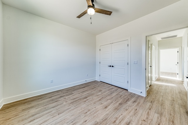 unfurnished bedroom featuring ceiling fan, a closet, and light hardwood / wood-style floors