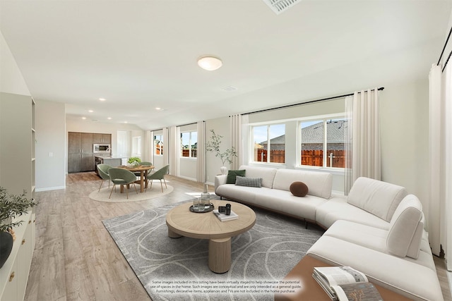 living room with light hardwood / wood-style flooring